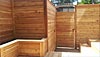 View of built-in planter, garden shed, stairs and gate