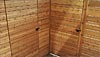 Detail of flush-mounted garden shed door and gate